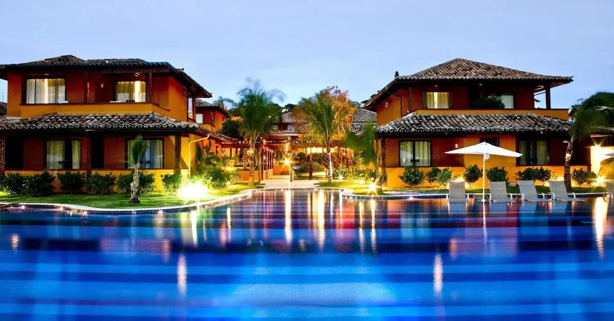The resort pool and buildings lit at dusk